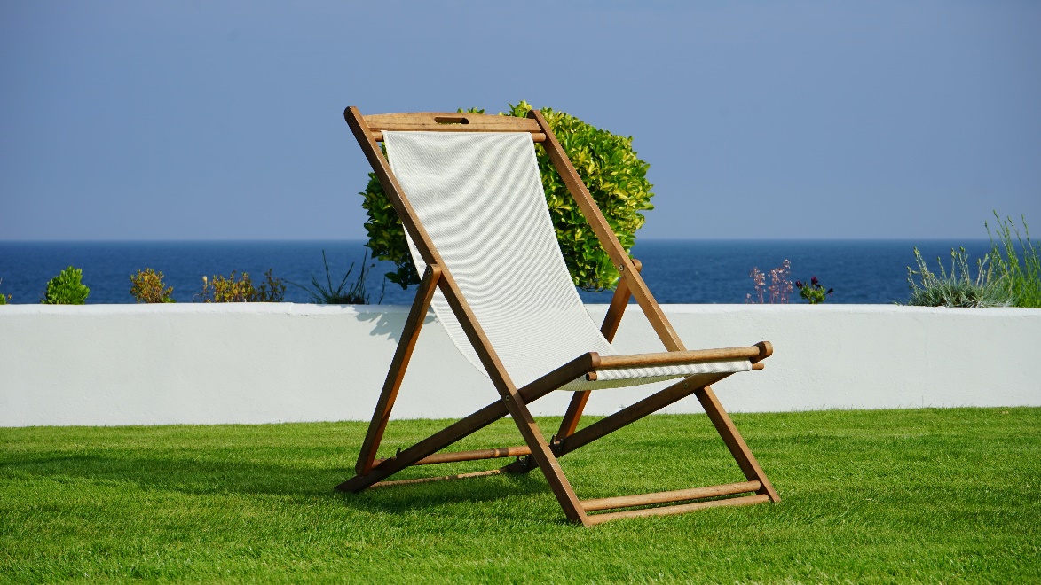 Brown and white lounger placed on artificial grass