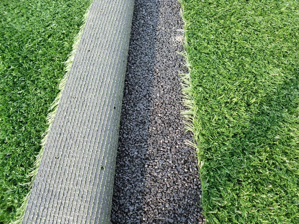 A rubber shock pad installed under artificial grass