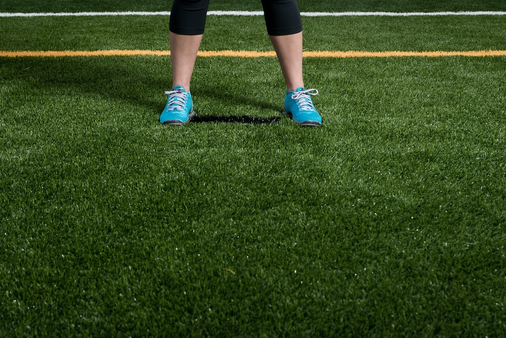A person standing on artificial grass