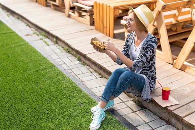 Woman sitting while holding food