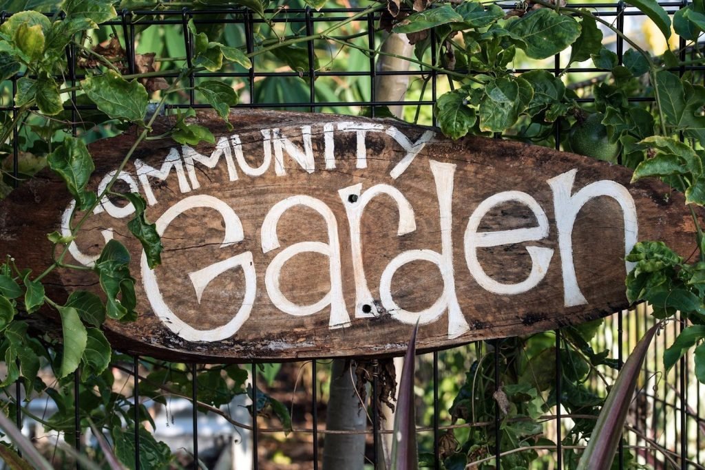 A wooden sign for the community garden
