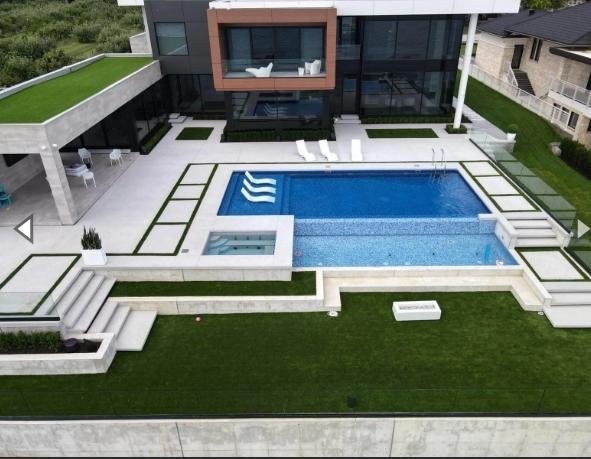 Artificial turf surrounding a residential building with clean, low-maintenance landscaping
