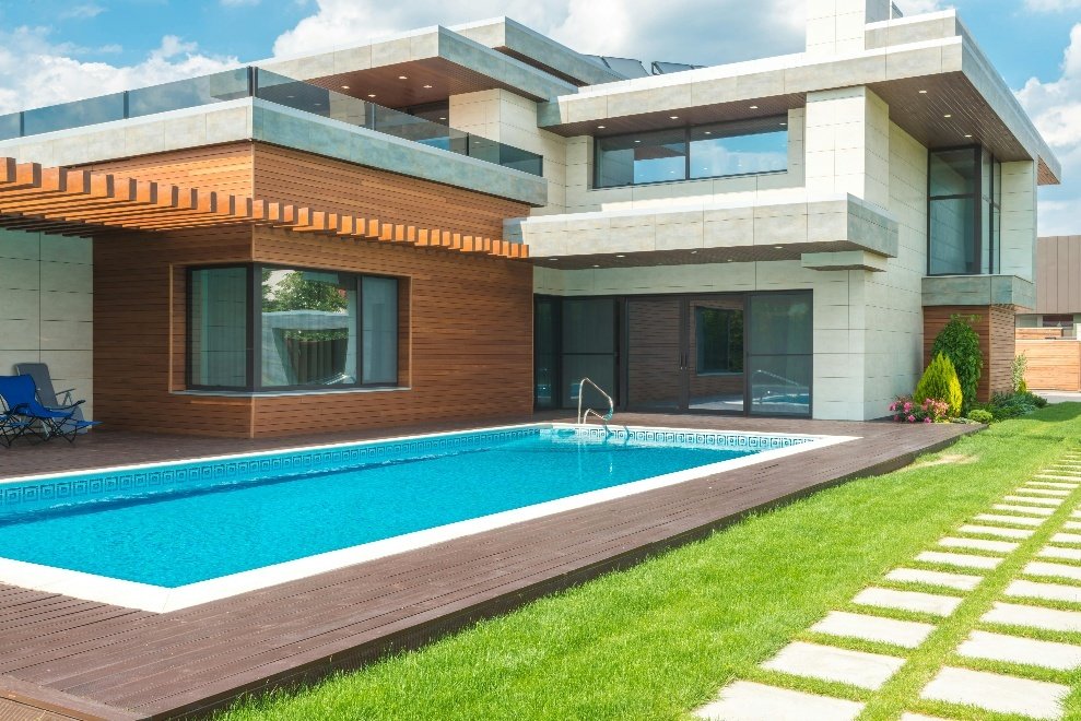 Paving blocks and turf near a stunning swimming pool