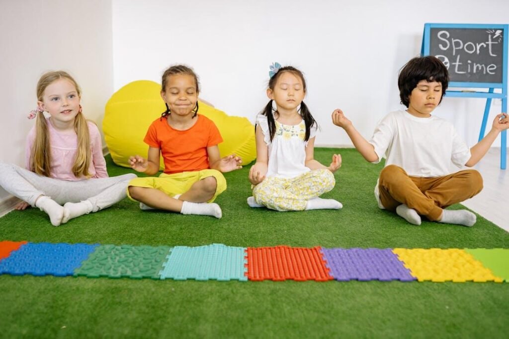 An image of kids sitting on synthetic grass in a yoga pose