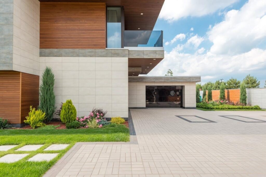 Tiled driveway with artificial turf strips between the tiles