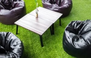 Tables and chairs arranged on artificial grass outdoors
