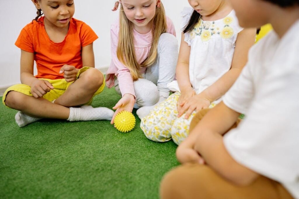 An image of children playing together on astro turf