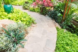 concrete curbing with different plants and pots on each side