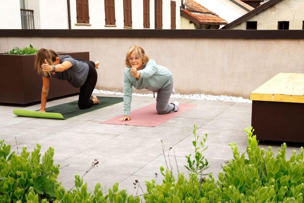 two women posing for yoga around plants