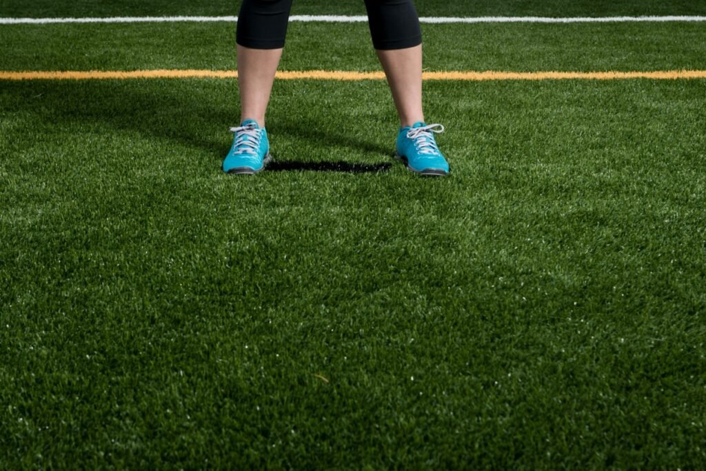 Person standing on lush artificial turf