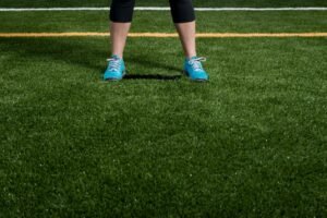 Person standing on lush artificial turf