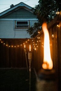 Backyard setup with fairy lights and a fire pit for evening gatherings