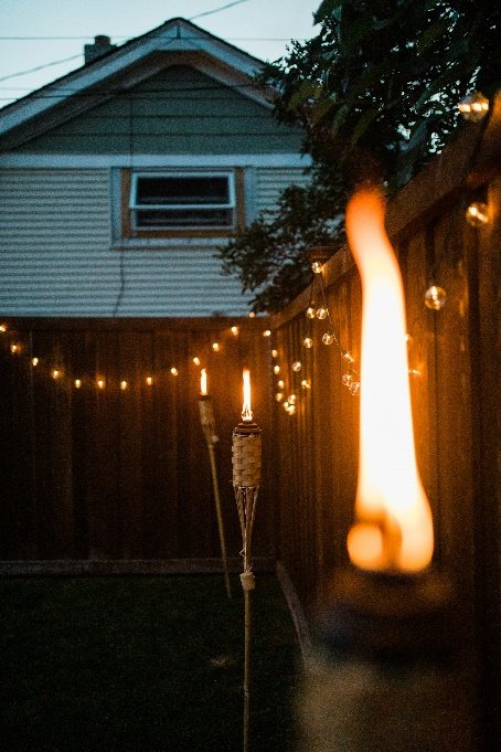 Backyard setup with fairy lights and a fire pit for evening gatherings