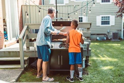Family relaxing and cooking barbecue in a multifunctional backyard