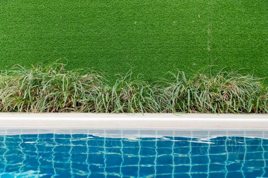 An image of artificial grass by the pool