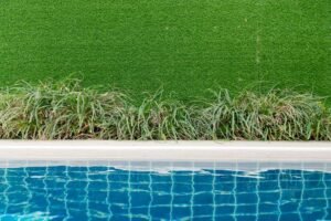 An image of artificial grass by the pool