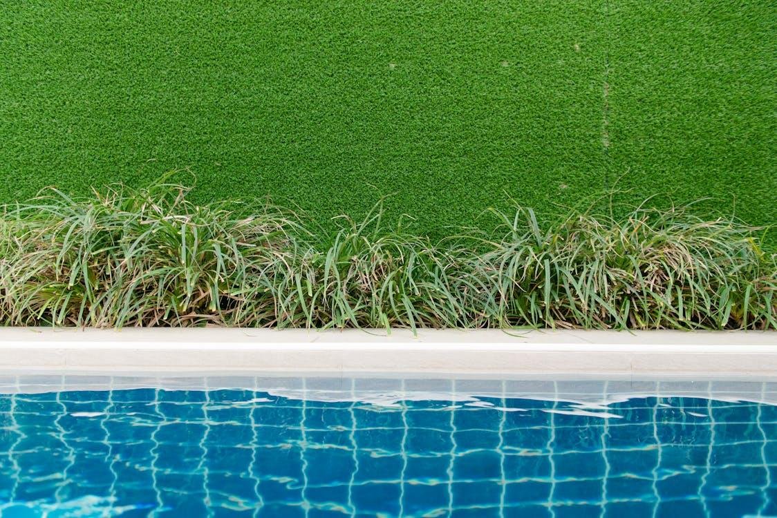 An image of artificial grass by the pool