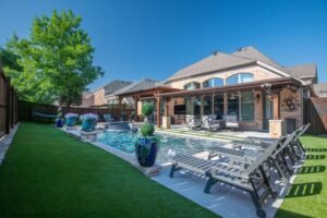 Backyard upgrade featuring artificial turf and modern landscaping at an Essex home