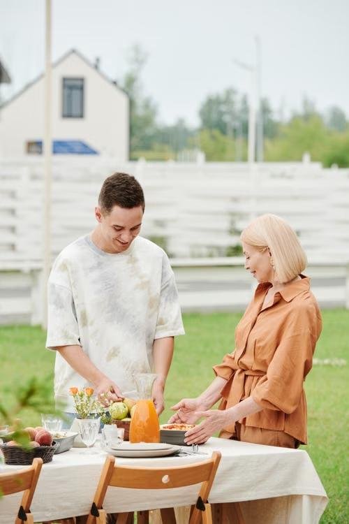 mother and her son preparing fruits in the yard