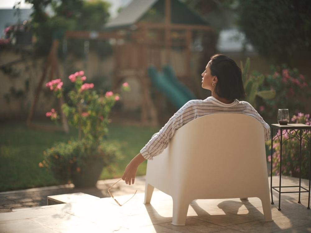 woman relaxing in a chair in her yard