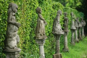 statues lined up in a backyard